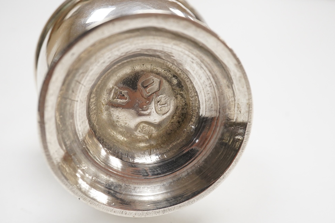 An early George II silver baluster pepperette, maker T?, London, 1734, with engraved crests, height 91mm, 82 grams.
